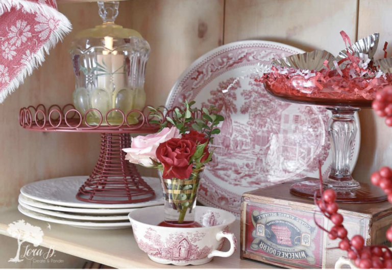 pink vintage dishes and cake stand on a shelf for Valentine's home decor